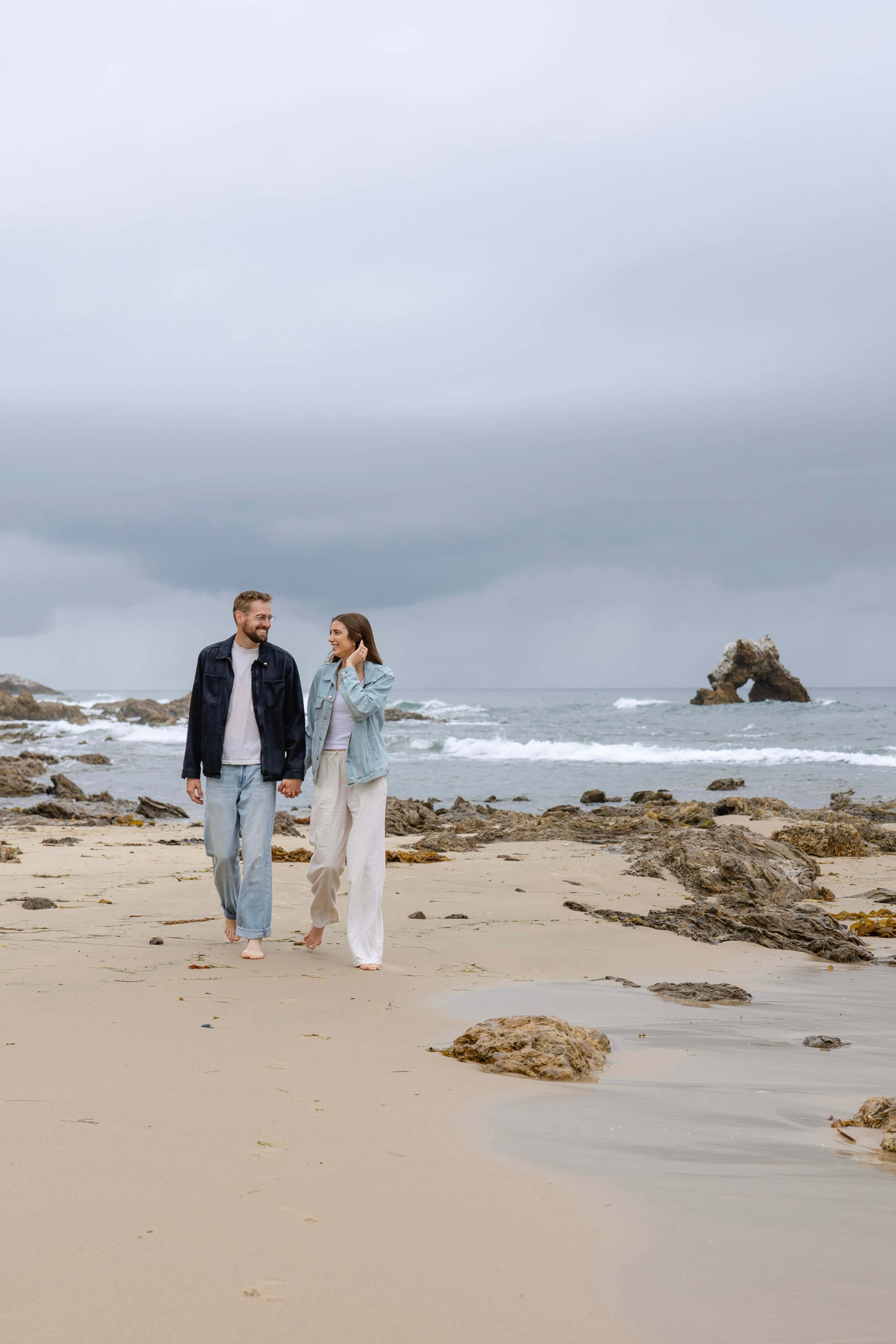 Michaela and Hunter walking along the Laguna Beach shoreline